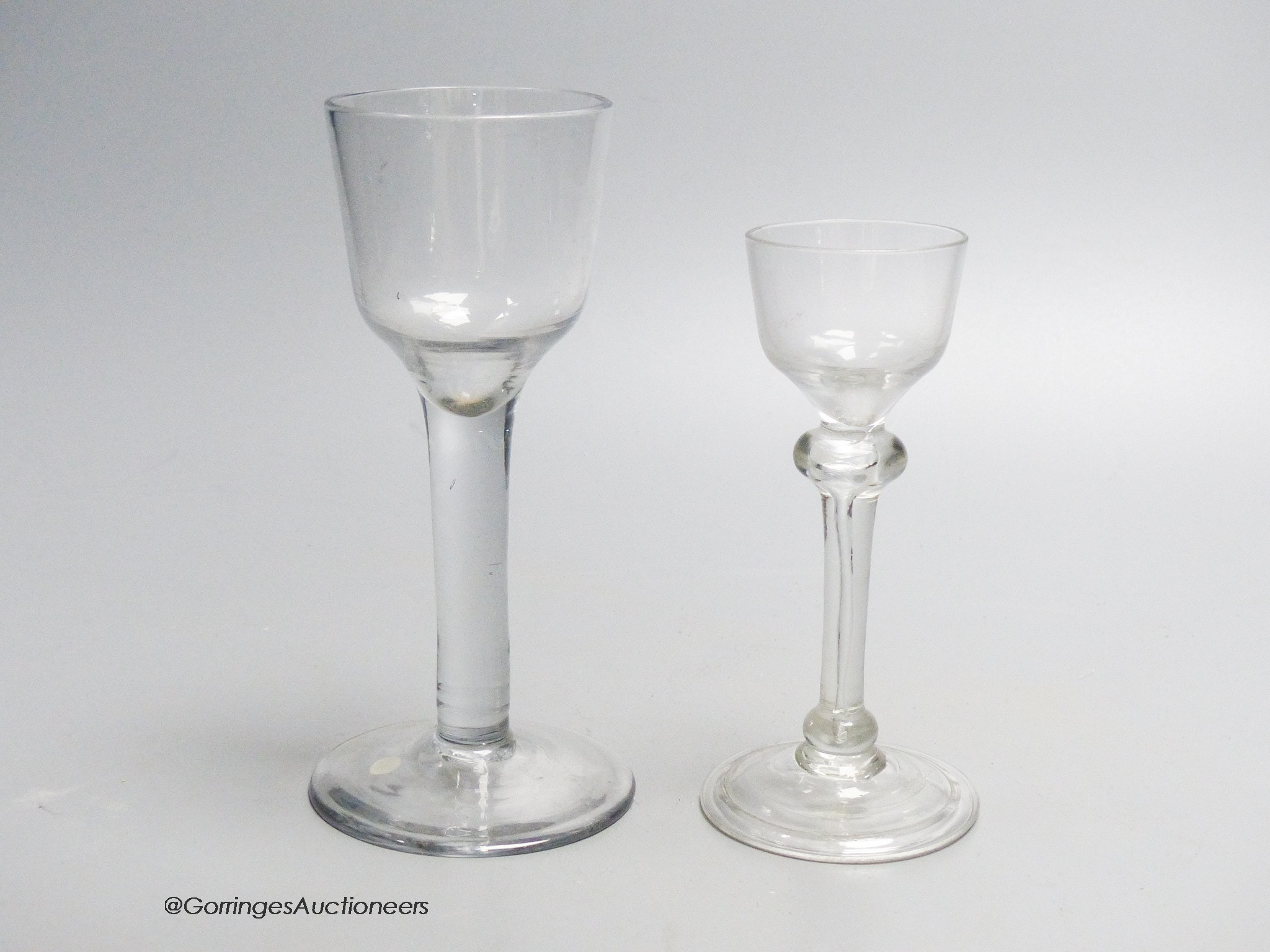 Two Georgian drinking glasses including a light baluster type cordial glass and a plain stem wine glass, tallest 16.5cm